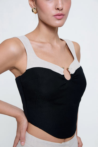 Woman wearing black and natural linen matching set, lifestyle - Anjum Khan