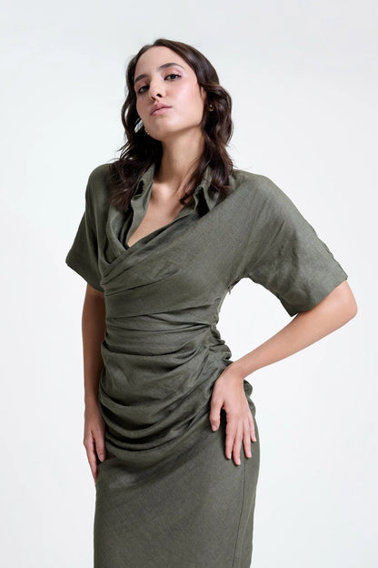 Woman wearing a ruched olive green dress with draped front and short sleeves