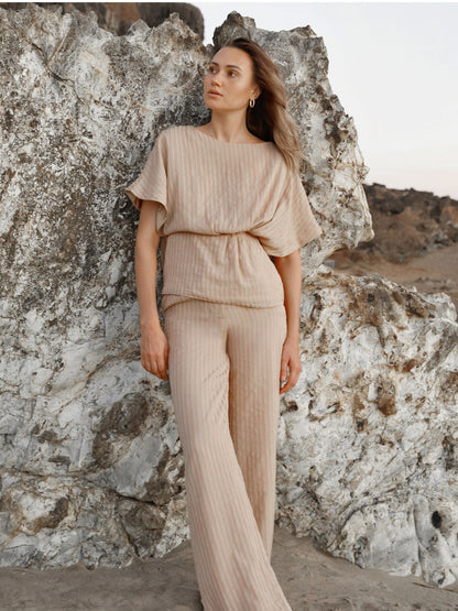 Full view of a woman wearing a striped wide leg lounge set, showcasing the complete look